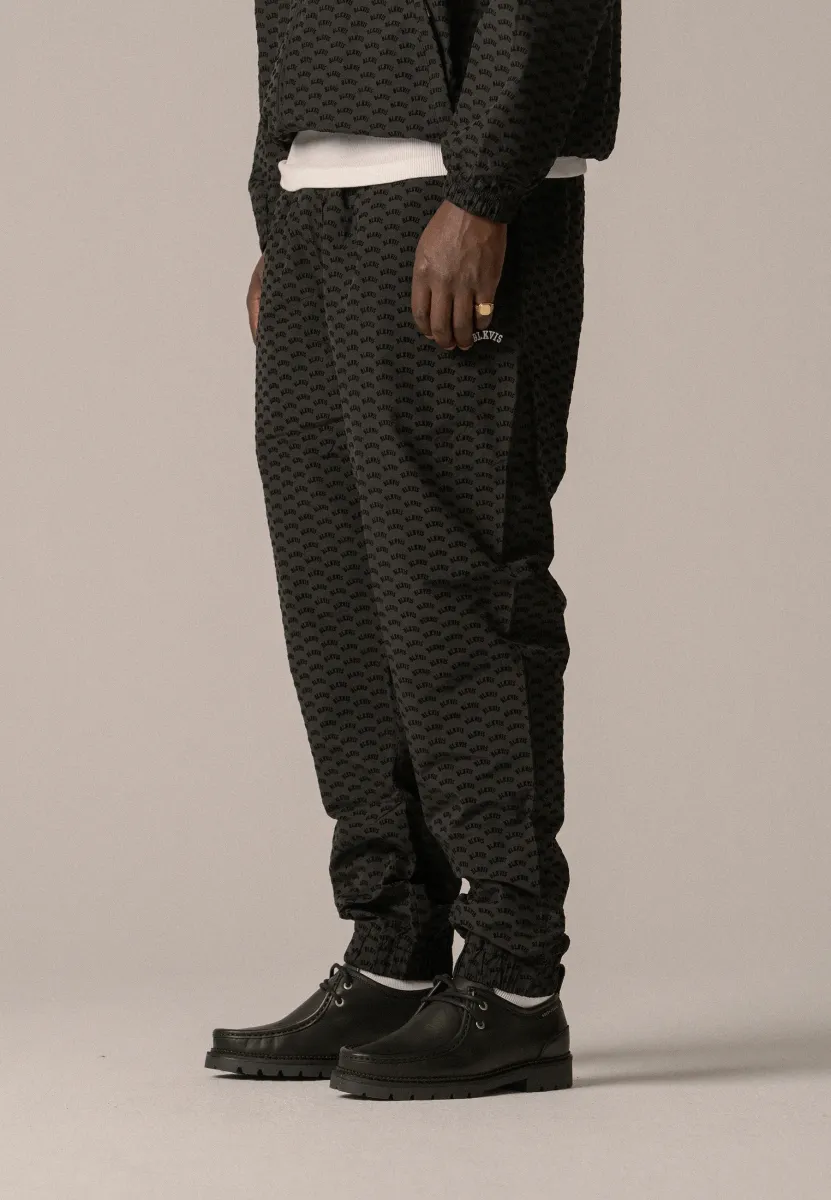 ALLOVER TRACK PANTS UNISEX - Jogginghose - black