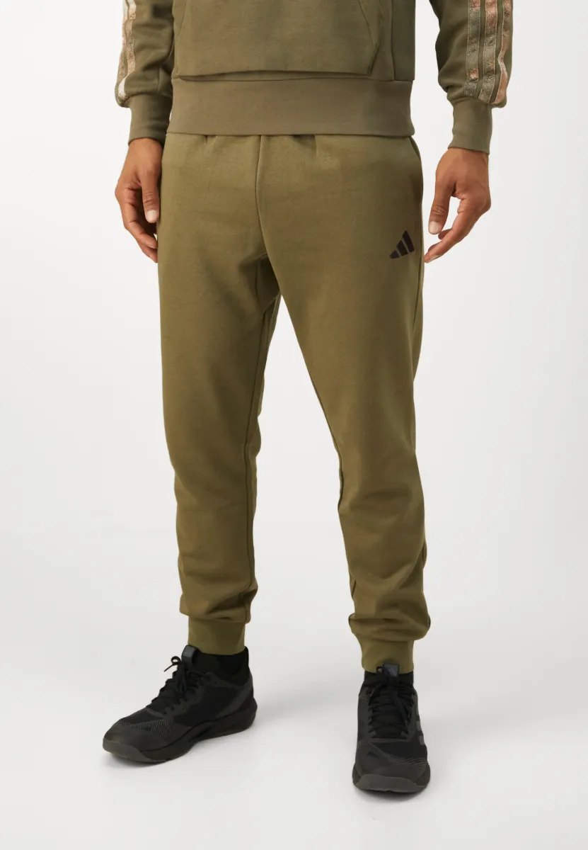 FEELCOZY - Jogginghose - olive strata black